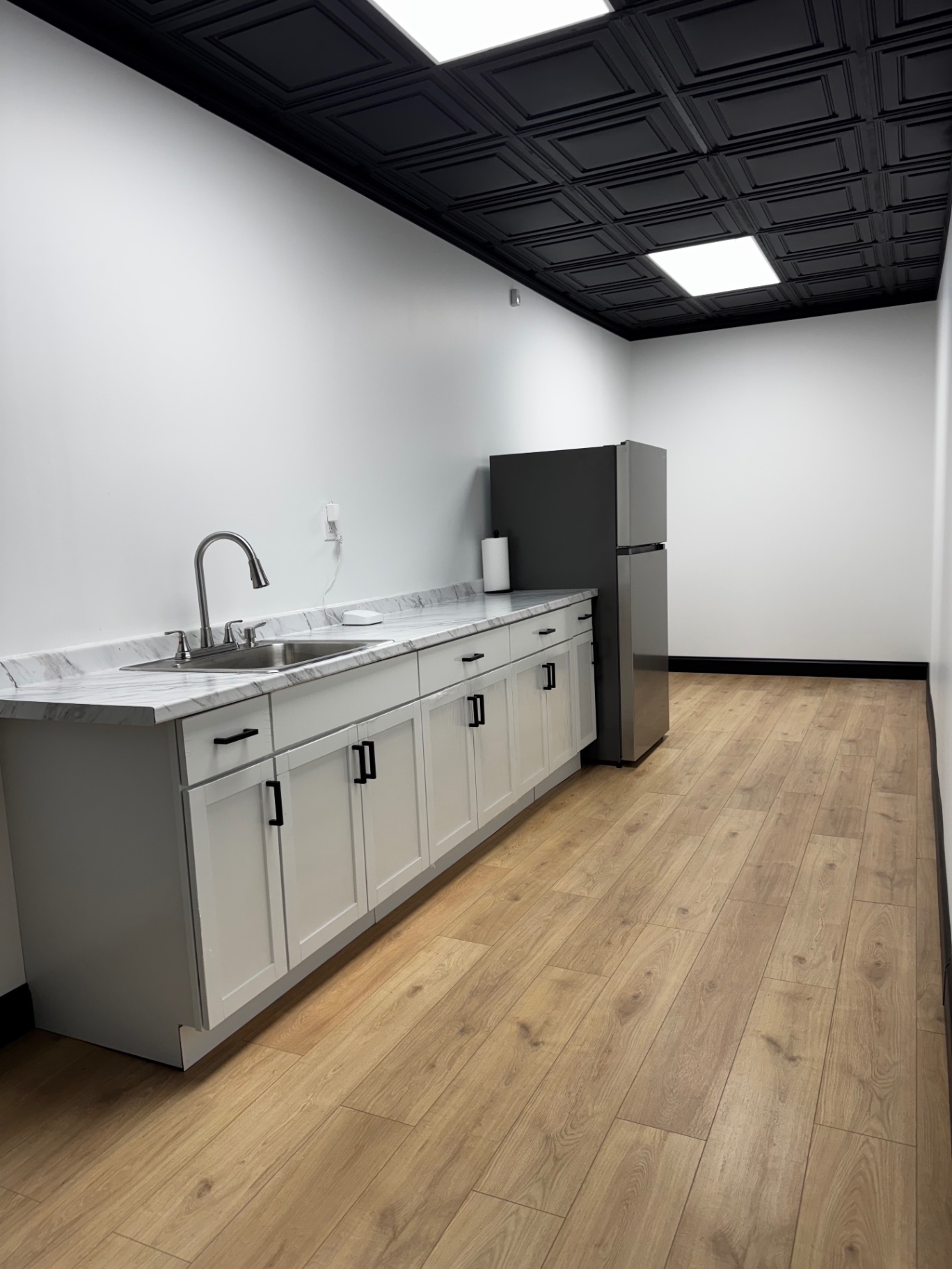 Prep kitchenette with sink, counters and refrigerator