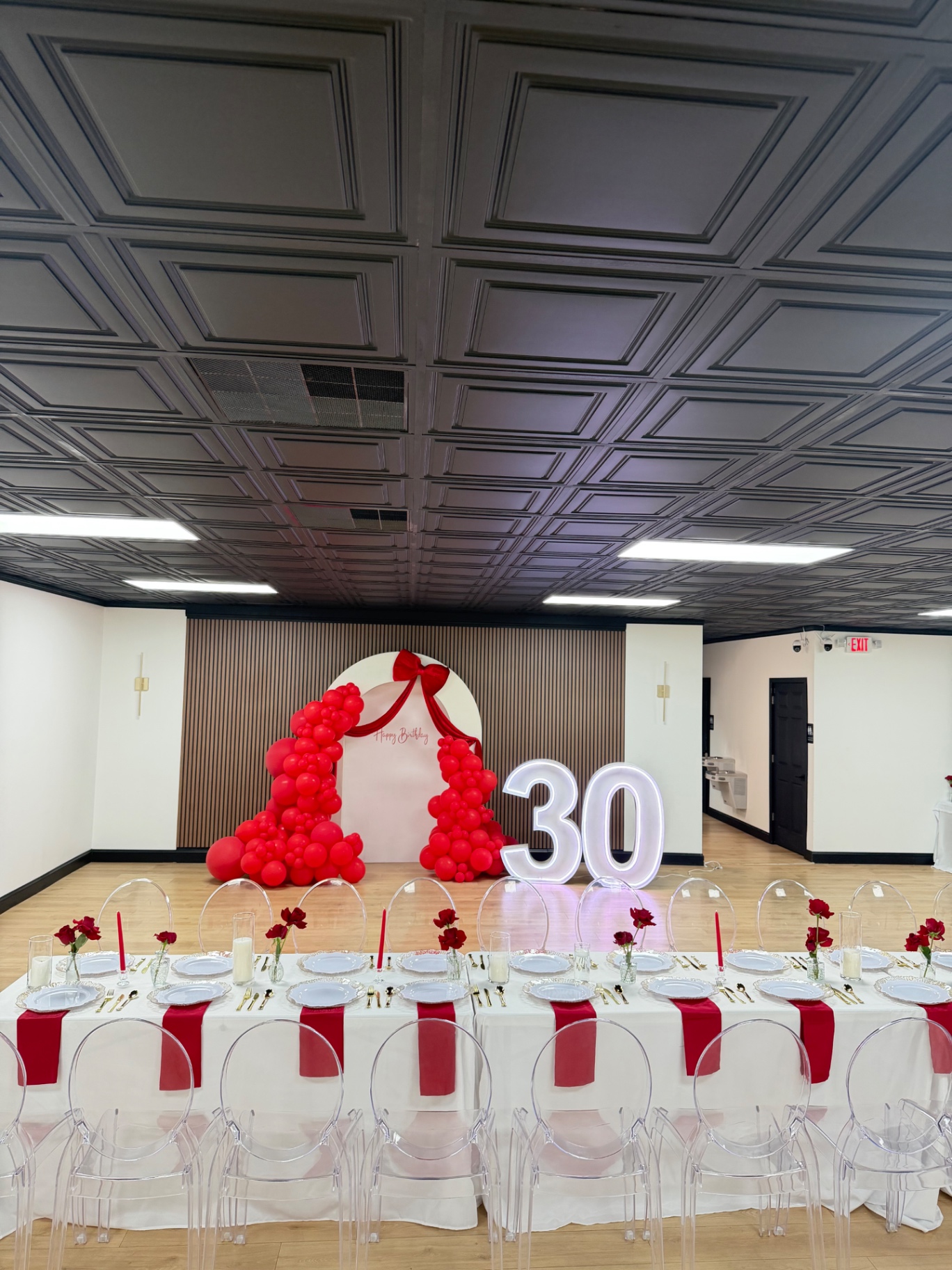 Milestone birthday with a bow backdrop and marquee numbers